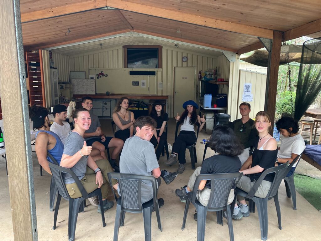 students sitting in a circle for lesson at visit 