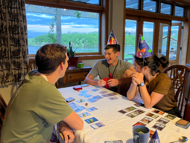 students playing cards in party hats